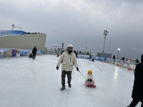 Dad and daughter enjoying sledding